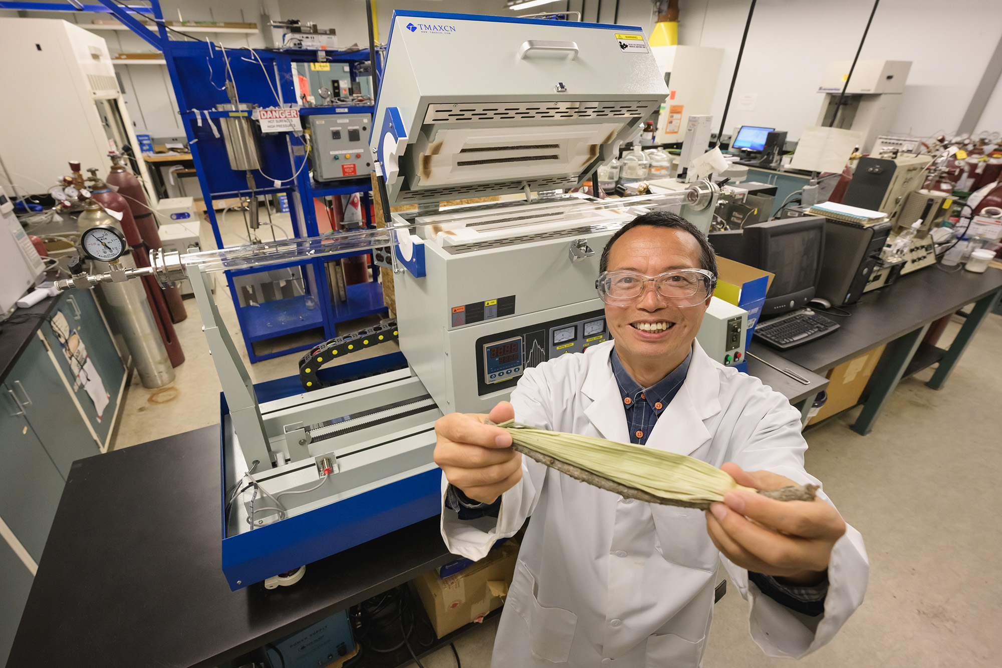 _URE9538 web Dr. Yong X. Gan in his U of R lab with a corn cob before it has been hydrothermally carbonized. (Photo by Trevor Hopkin)