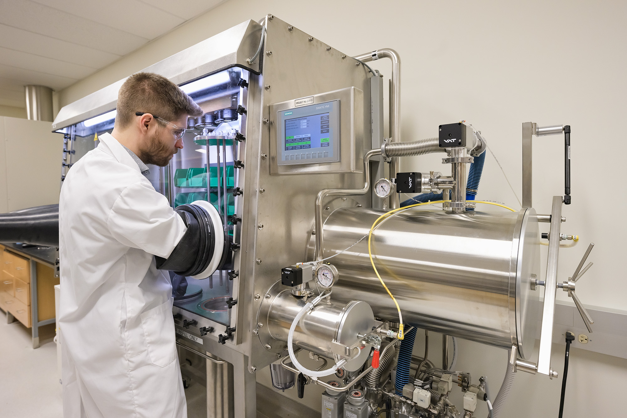 _URE4550 web. Dr. Arthur Situm working at the molten salt glove box used to handle radioactive materials. (Photo by Trevor Hopkin)