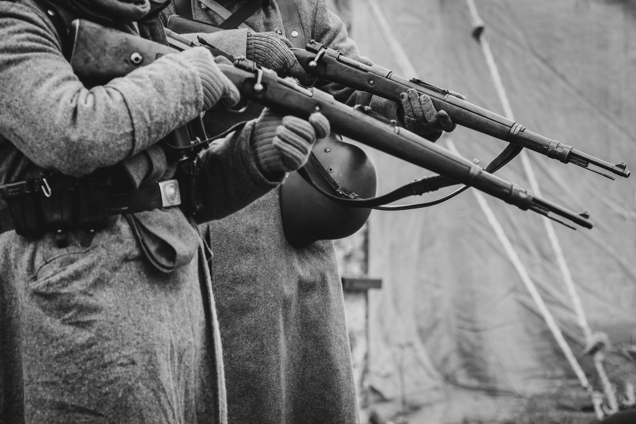The soldiers of the German army the second world war with rifles Two German soldiers of the Second World War with rifles in their hands ready to fire. Black and white photo