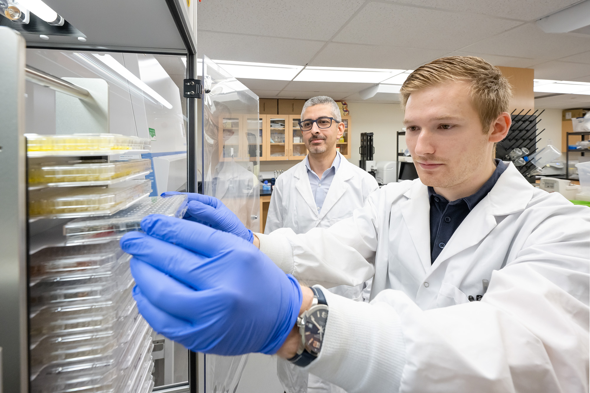 Colin Rieger, U of R graduate student in biochemistry and lead author of the study, in the lab with his supervisor, Dr. Omar El-Halfawy. (Photo by Trevor Hopkin)