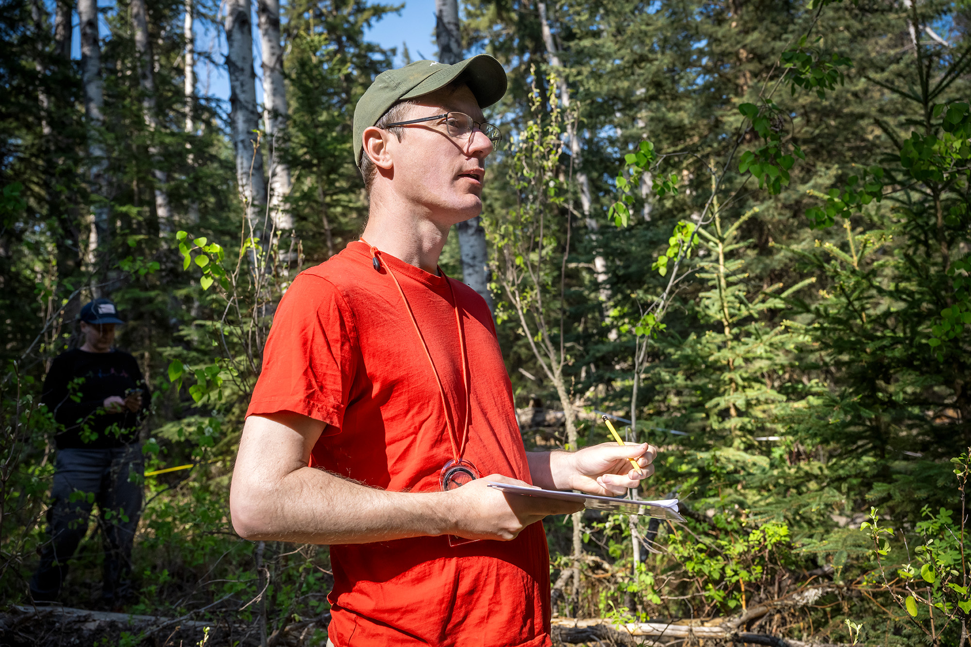 25-040-298 web Dr. Mark Vanderwel writes down data about the trees that the research team relays to him. (Photo by Trevor Hopkin)