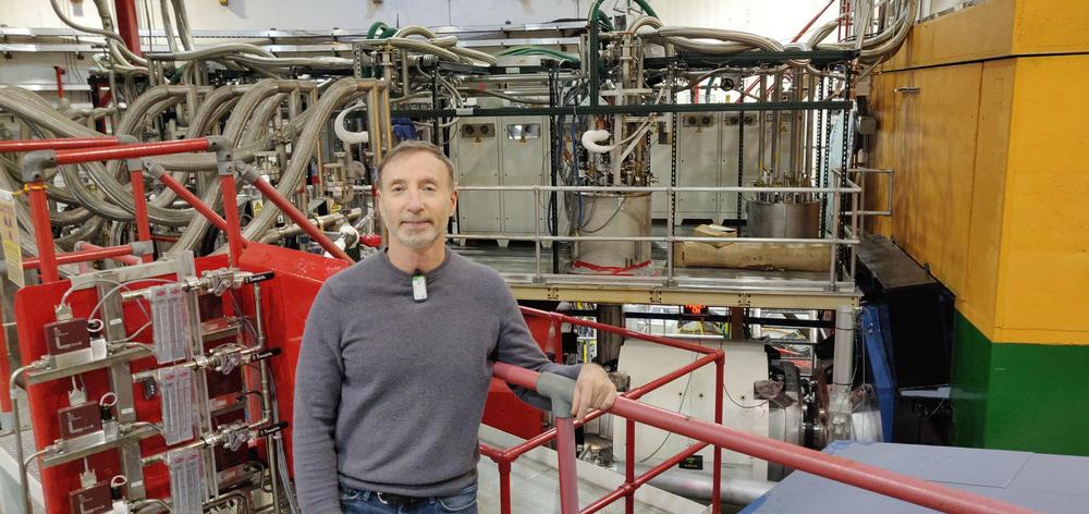 Dr. Garth Huber in Hall C at Jefferson Lab, in front of the high momentum particle spectrometers.  (Photo by Vijay Kumar).